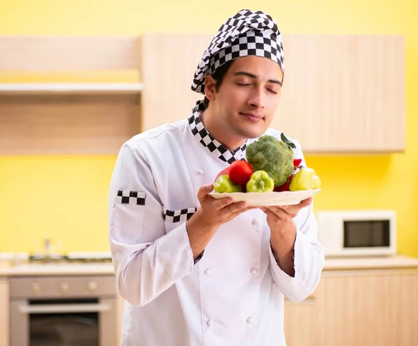 Jovem cozinheiro profissional preparando salada em casa — Fotografia de Stock