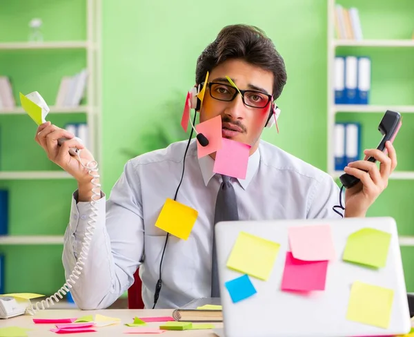 Young help desk operator working in office with many conflicting — Stock Photo, Image