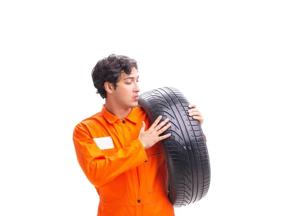 Молодий працівник гаража з шиною ізольовано на білому — стокове фото