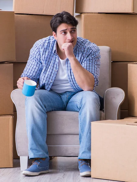 Young man moving in to new house with boxes