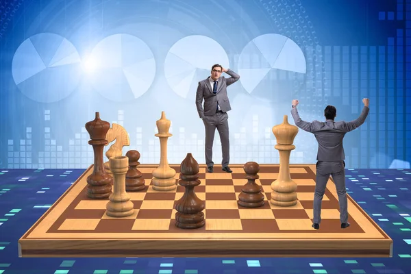 Businessman in large chess board in strategy concept — Stock Photo, Image