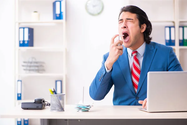 Young male employee suffering in the office — Stock Photo, Image