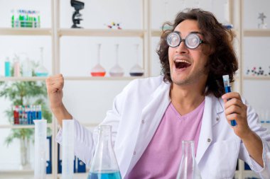 Laboratuvarda çalışan komik erkek kimyager.