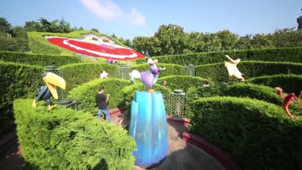 People in garden in Fantasyland of Disneyland in Paris — Stock Video