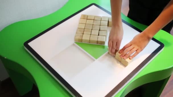 Girl putting wooden blocks — Stock Video