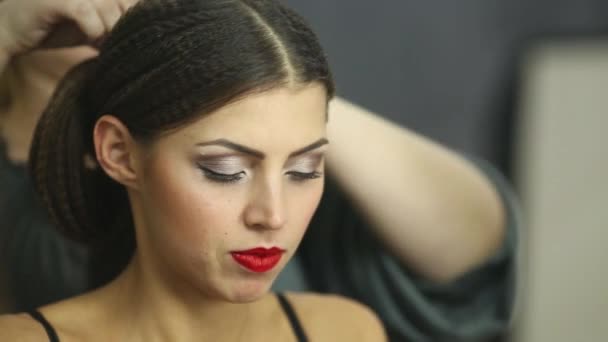 Visagiste делает прическу для девушки модели — стоковое видео