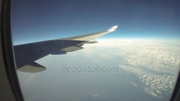 Wolken en vleugel gezien door het raam van jet vliegtuig — Stockvideo