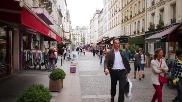 People walk by a pedestrian street — Stock Video