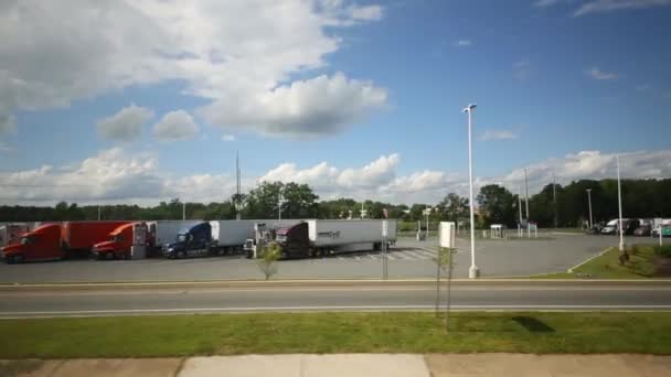 Cars on highway near parking with trucks — Stock Video