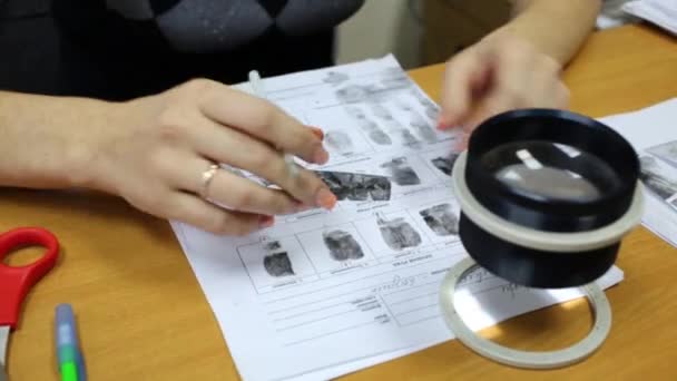 Woman working with fingerprint in police — Stock Video