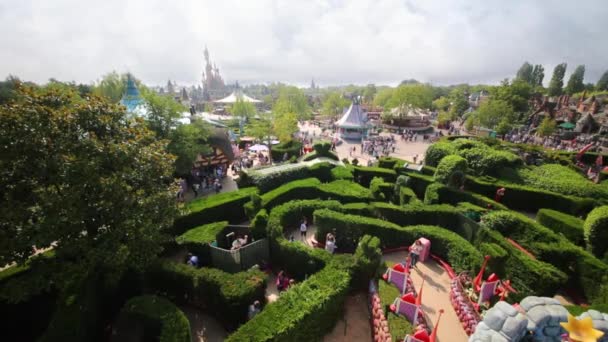 People walk in garden in Fantasyland of Disneyland — Stock Video