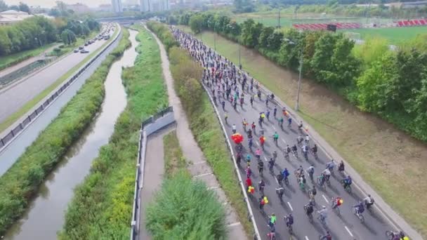Большая группа велосипедистов едет на спидвее — стоковое видео