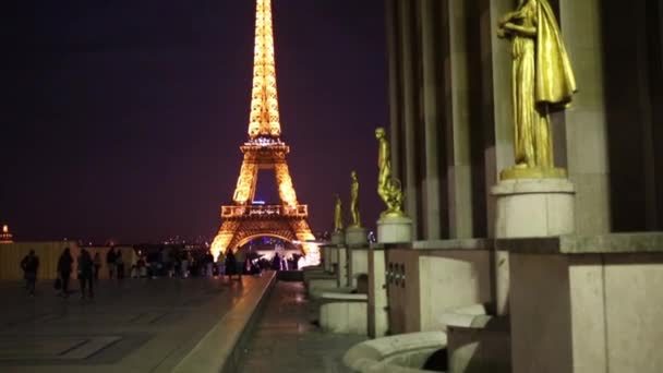 Sculpturen en de toren van Eiffel in Parijs 's nachts — Stockvideo