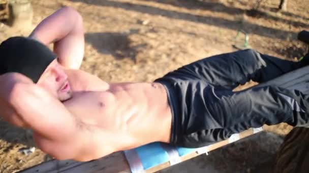 Young half-naked man in does exercise — Stock Video