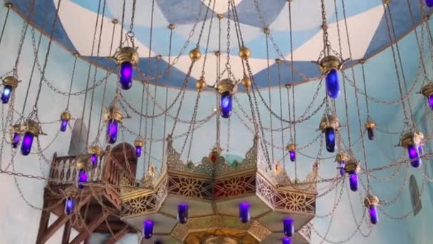 Arabic wrought chandelier with chains hangs on ceiling — Stock Video