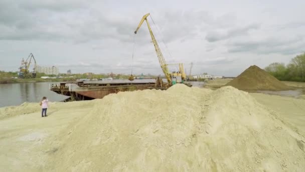 Gru scarica sabbia da nave da carico a riva — Video Stock