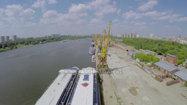 Port fluvial avec grues et bateaux amarrés — Video