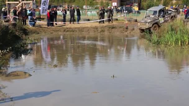 Джип ездит в грязной луже в бездорожье конкуренции — стоковое видео