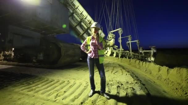 Female worker is talking on walky-talky near career stacker — Stock Video