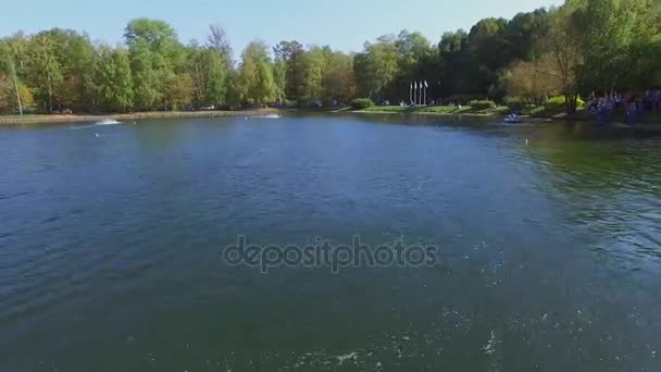 Menschen beobachten Wettbewerb der Schiffsmodelle auf dem Teich — Stockvideo