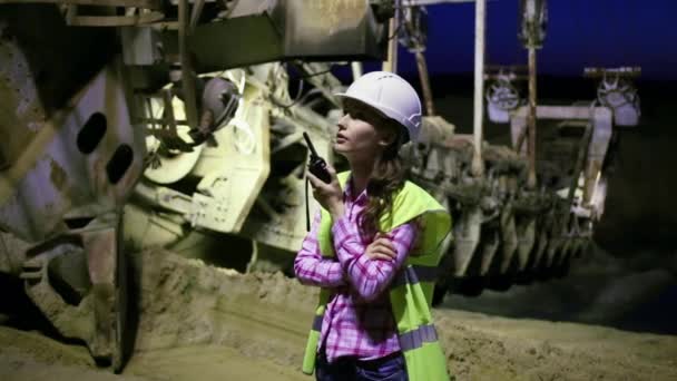 Female worker is talking on a radio near career Stacker — Stock Video