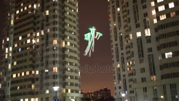 Illuminated helicopter ghost at night near building — Stock Video