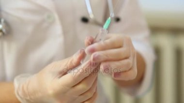Ellerinde eldiven bir kadın doktor ilaç ile şırıngadan hava bültenleri.
