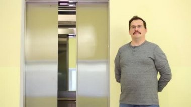 Adam bir düğme ve ayakta açık asansörde presler