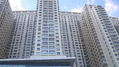 Pek çok windows ve mavi gökyüzü bulutlu yüksek büyük bina