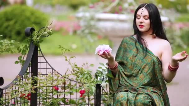 Woman Sitting Small Fence Smelling Rose Bud Her Hand Laughing — Stock Video