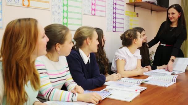 Seven Girls Looks Teacher Who Points Finger Book Camera — Stock Video