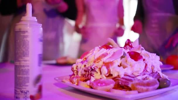 ホイップ クリームとフルーツと照明を持つ人々 の手でパンケーキのケーキ — ストック動画