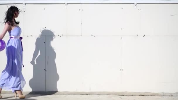 Женщина Синем Платье Каблуках Воздушными Шарами Идущими Вдоль Стены Крыше — стоковое видео
