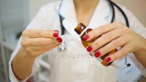 Female Doctor Pours Medicine Syrup Plastic Measuring Spoon — Stock Video