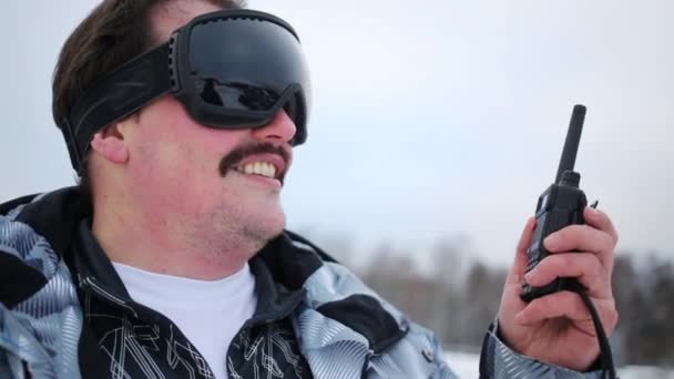 Man Black Ski Goggles Holds Radio Outdoor Smiles — Stock Video