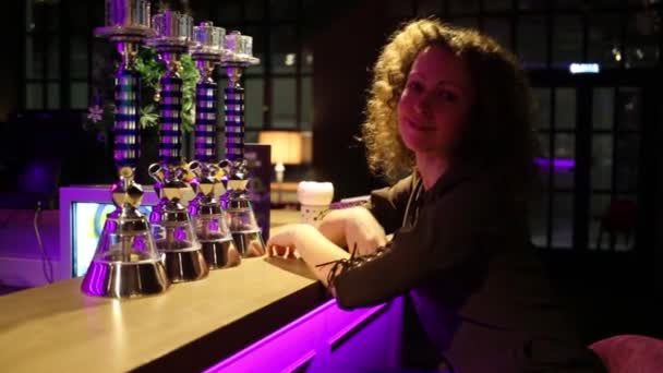 Beautiful Smiling Woman Curly Hair Sitting Bar Neon Lights — Stock Video