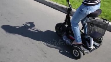 Elektrikli bisiklet park de yol sürüş kadın ile yetişkinler için.