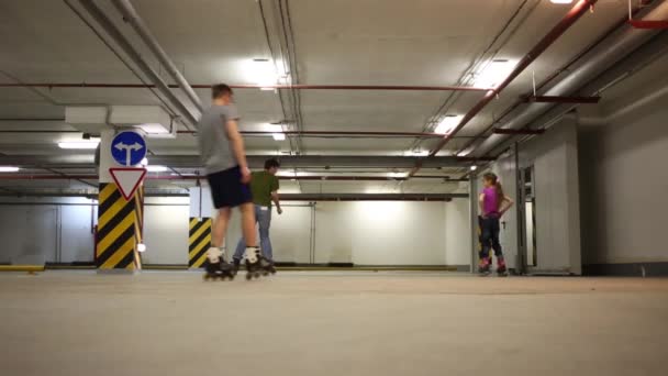 Two Men Girl Roller Skate Indoor Underground Parking — Stock Video