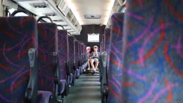 Boy Girl Sitting Back Seat Empty Bus — Stock Video