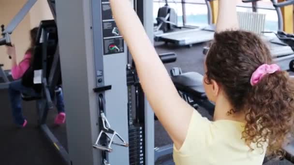 Frau Trainiert Armmuskulatur Simulator Fitnessclub Mädchen Aus Dem Fokus — Stockvideo