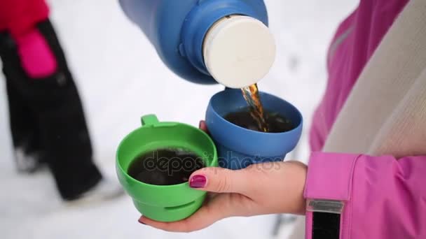 Female Hand Pours Hot Tea Thermos Two Cups Winter Day — Stock Video
