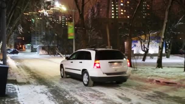 White Car Goes Away Winter Night Blinking Lights — Stock Video