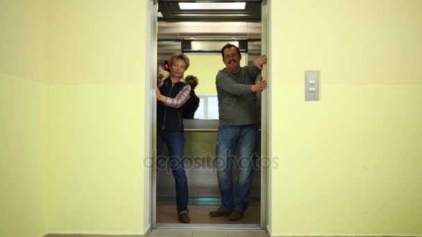 Man Woman Stands Elevator Keep Its Doors Hands — Stock Video