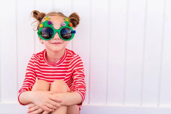 Little girl in funny Christmas glasses — Stock Photo, Image