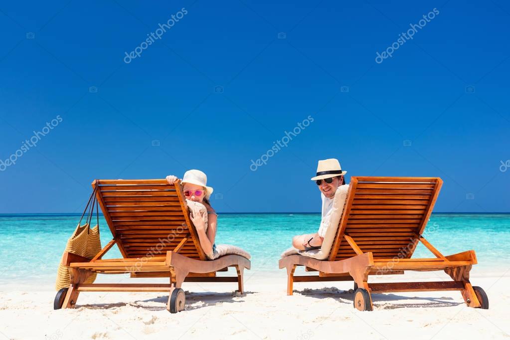 Father and his adorable little daughter at beach enjoying tropical vacation