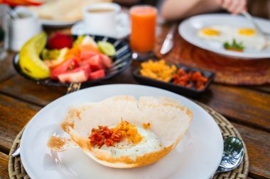 Traditional Sri Lankan breakfast with egg hoppers clipart