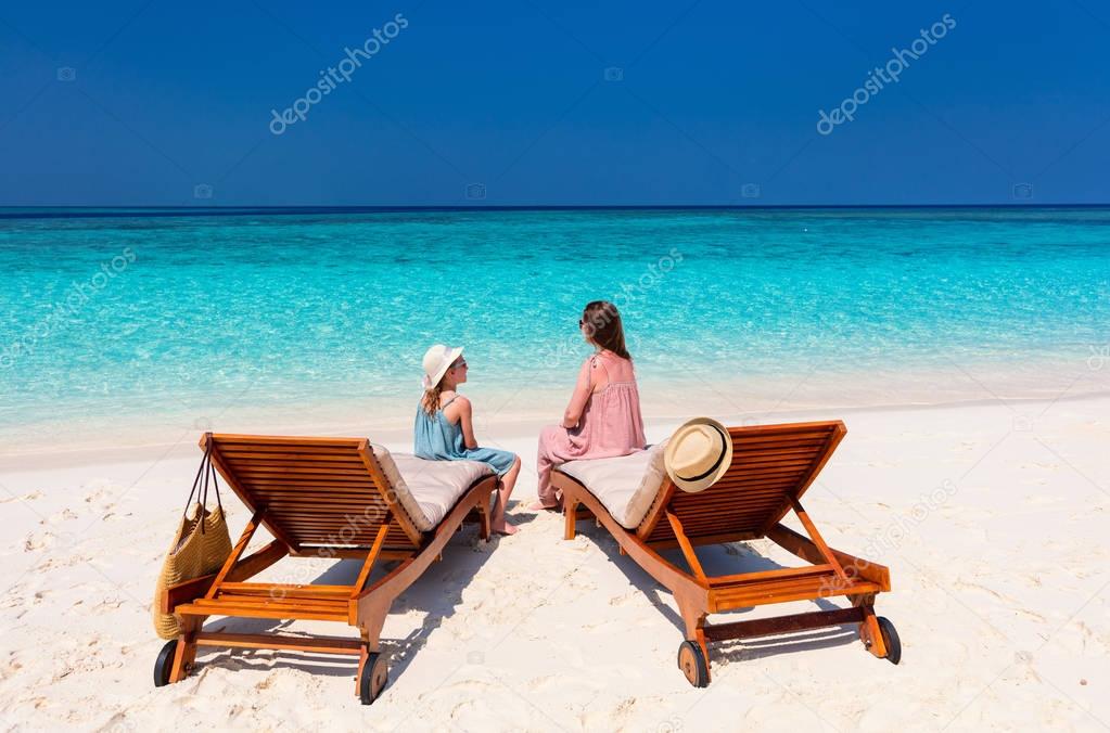 Mother and daughter enjoying tropical beach vacation