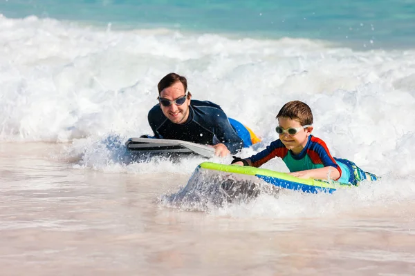 父亲和儿子在冲浪板上冲浪 — 图库照片
