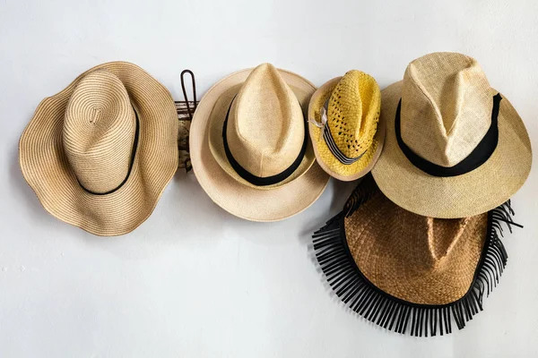 Straw hats on a rack close-up view