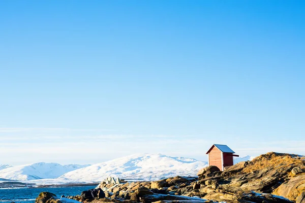 北ノルウェーの海岸の美しい冬の風景 息をのむようなフィヨルドの景色を見下ろす木造の小屋 — ストック写真